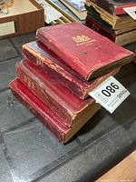 Stack of four red cloth infantry manuals