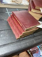 Stack of four small red military manuals, edge view