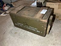 Overall view of olive drab wooden military chest