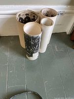 Four rolled panoramic photographs standing upright