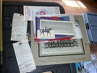 Overview of insignia in packages, mounted photo and documents