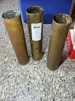 Three brass shell casings standing upright