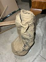 Sleeping sack rolled and tied for storage