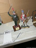 Front view of both cast metal soldier figurines showing size and detail
