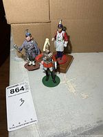 All three hand-painted metal soldier figurines together
