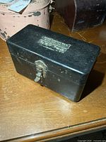 Top view of black metal Astro Compass MK II box showing latch and stencilled lettering
