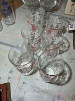 Overhead view of six printed juice glasses showing overall condition and design