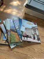 Stack of magazines showing Buckingham Palace cover on top with visible others beneath