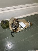 Gas mask folded with filter and goggles visible