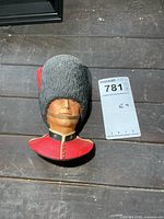 Front view of Guardsman bust beside lot card