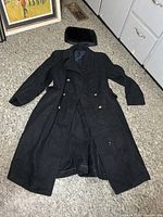 Coat and hat laid flat, showing overall condition