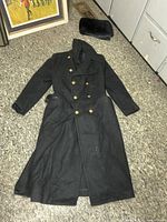 Full view of coat and hat on floor