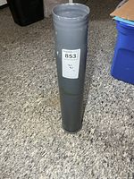 Full view of grey painted shell casing standing upright