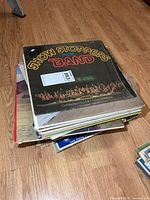 Stack of LPs showing top record Show Stoppers for Band