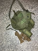 canvas bags and padded vest spread on floor