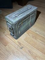 Side view of ammunition box showing overall form and wear