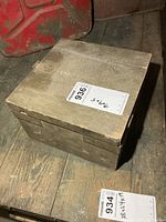 Oblique view of closed wooden military box on wood floor