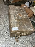 Top and side view of wooden military crate showing rope handle and stenciled markings