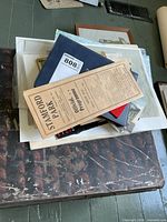 Stack of albums, programme and assorted papers
