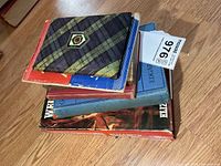 Stack of vintage military books showing covers and bindings