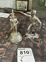 Both pewter military figurines side by side on table