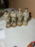 Front view of all four porcelain soldier figurines