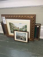Group shot showing two framed prints and empty display frame