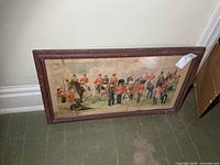 Full view of framed print resting against wall