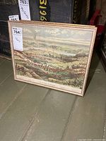 Framed print standing on floor showing full artwork