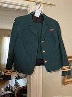 Front view of jacket and skirt displaying buttons, ribbon bar and sleeve braid