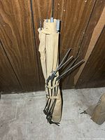 Folded khaki canvas cot showing metal poles and legs