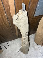 Rolled canvas cot standing upright