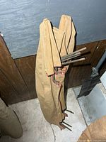 Full folded cot leaning against wall