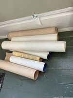 Eight rolled posters on floor