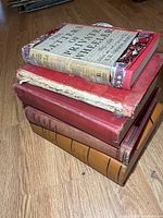 Stack of six war-related hardcover books showing spines and covers