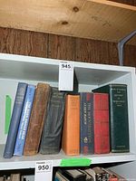 Spine view of seven war-related hardcover books on shelf