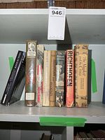 Seven war-related hardcovers on shelf