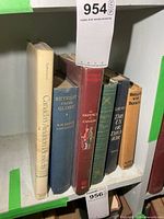 Row of six visible military/aviation books on shelf