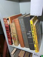 Shelf showing eight war-related books spine-out
