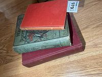 Stack of three hardcover war books showing covers and general wear