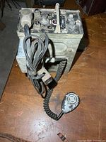 Angled view of radio with attached microphone and cabling