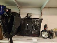 pannier, mesh basket, flashlight, lock and bottle cage on shelf