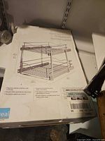 Box showing product diagram of two-tier pullout organizer