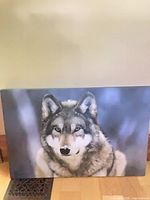 front view of wolf canvas print leaning against wall