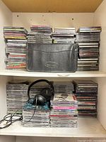 Overview of shelves with stacked CDs, CD wallet centered