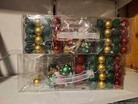 Stacked clear boxes showing quantity and mixed colours of ornaments
