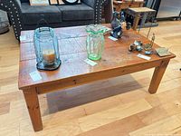 top and side view of rectangular wood coffee table showing overall style and surface wear