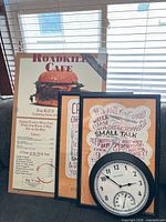 Group shot showing all items: menu board, two framed prints, wall clock