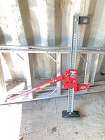 Full view of Bulldog farm jack with red mechanism, grey beam, black base