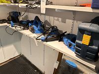 Shelf with multiple blue Mastercraft power tools and chargers